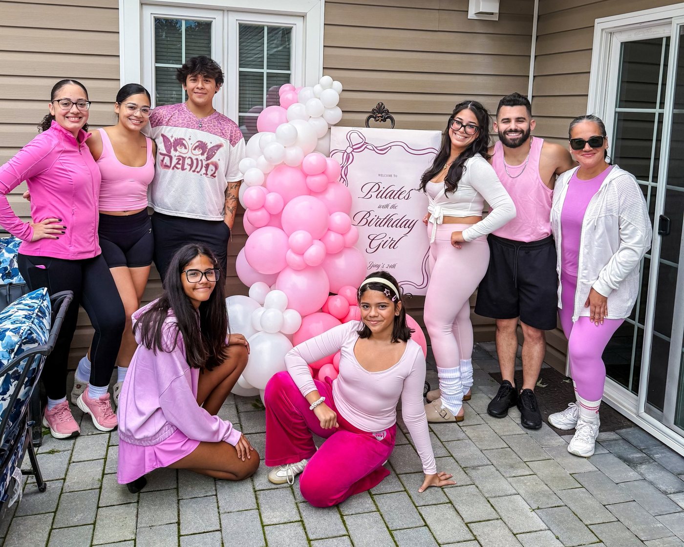 Birthday group in pink with balloons at a private Pilates party